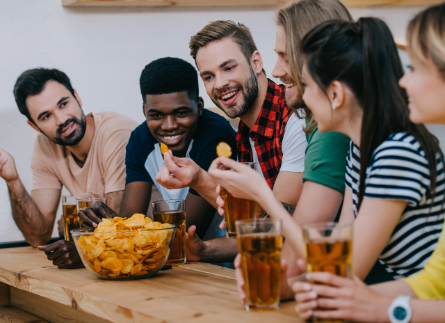 smiling-group-of-multicultural-friends-eating-chip-2023-11-27-04-58-29-utc
