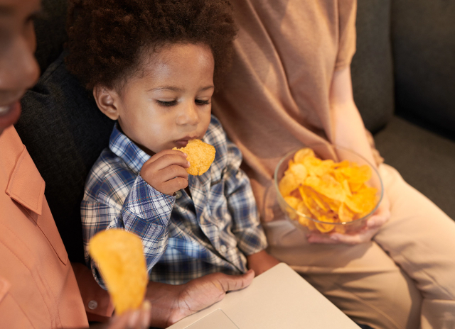 toddler-boy-eating-vegetable-chips-2023-11-27-05-28-20-utc